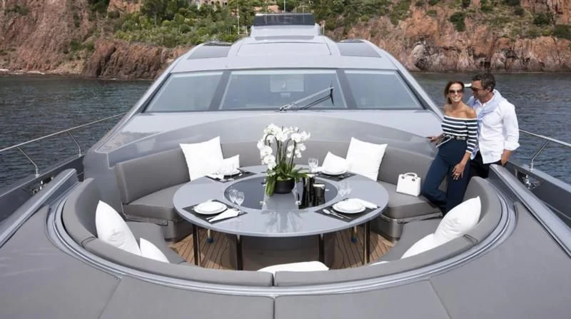 a man and woman sitting on a boat with a table and chairs aboard MUSE Yacht for Sale