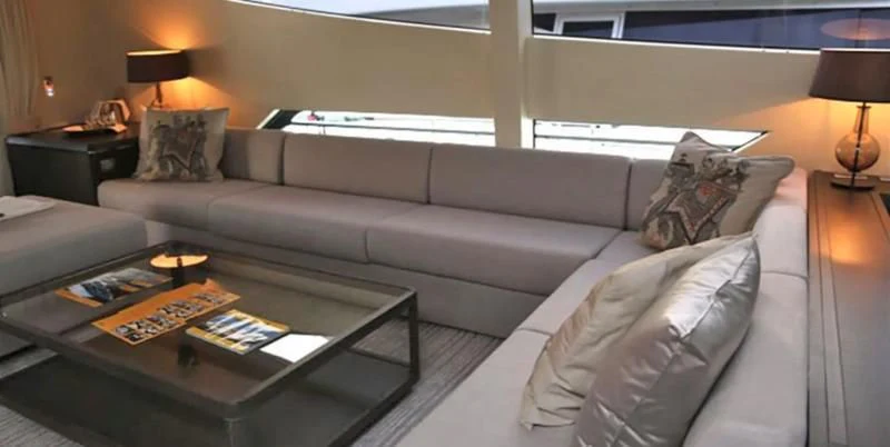 a living room with a white couch aboard MUSE Yacht for Sale