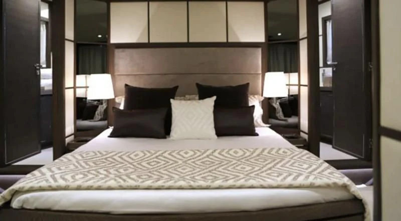 a large bed with pillows aboard MUSE Yacht for Sale
