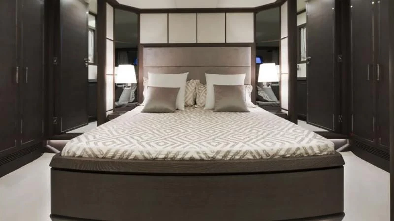 a bed with white sheets aboard MUSE Yacht for Sale