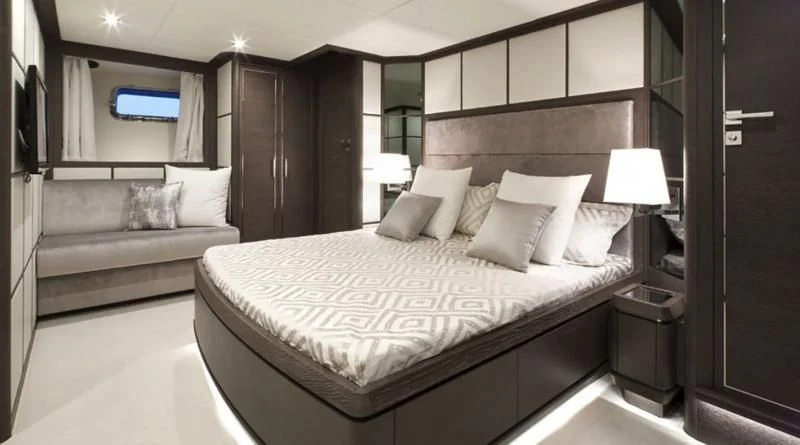 a bed with white pillows aboard MUSE Yacht for Sale