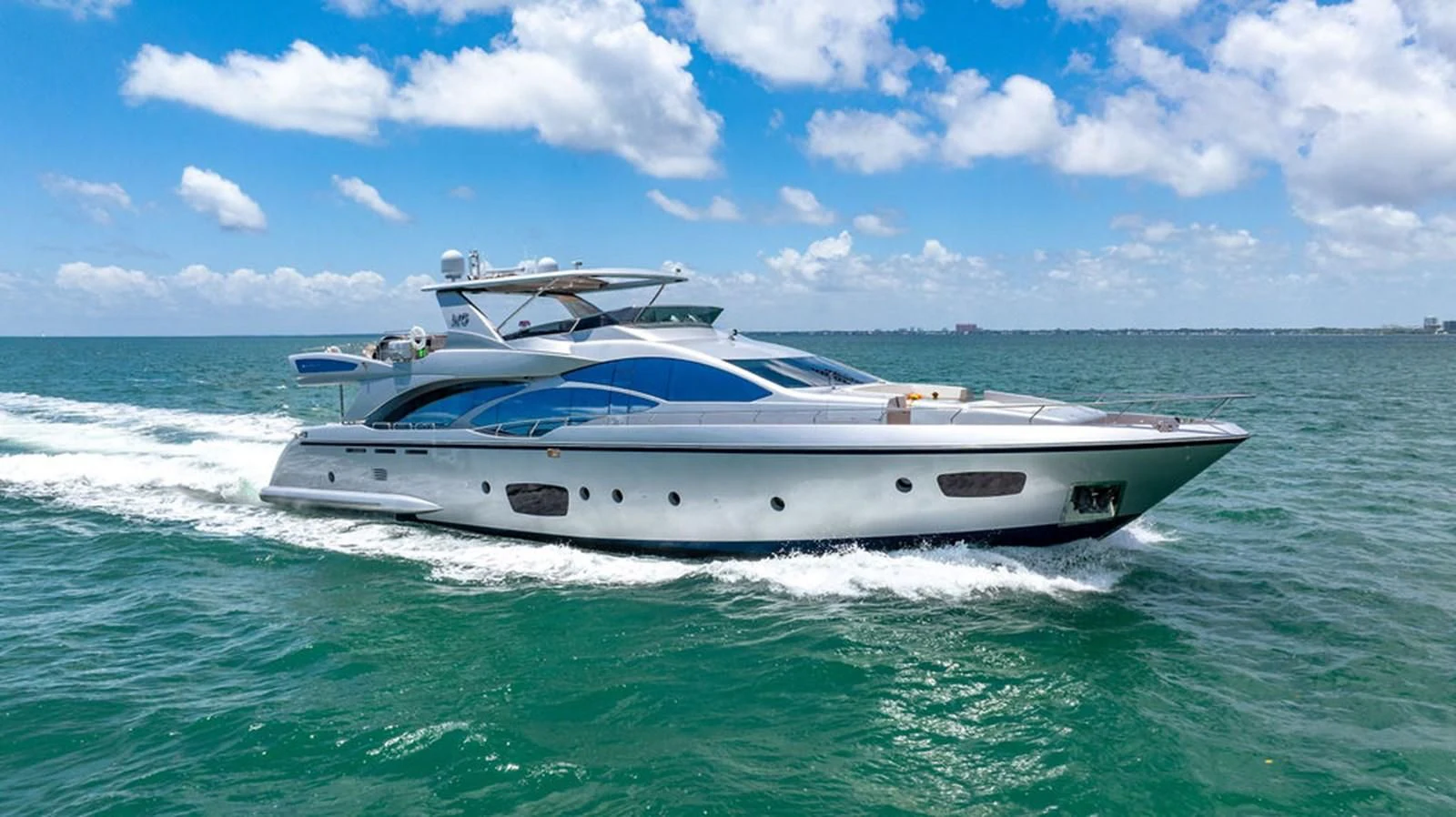 a white boat on the water aboard BM Yacht for Sale