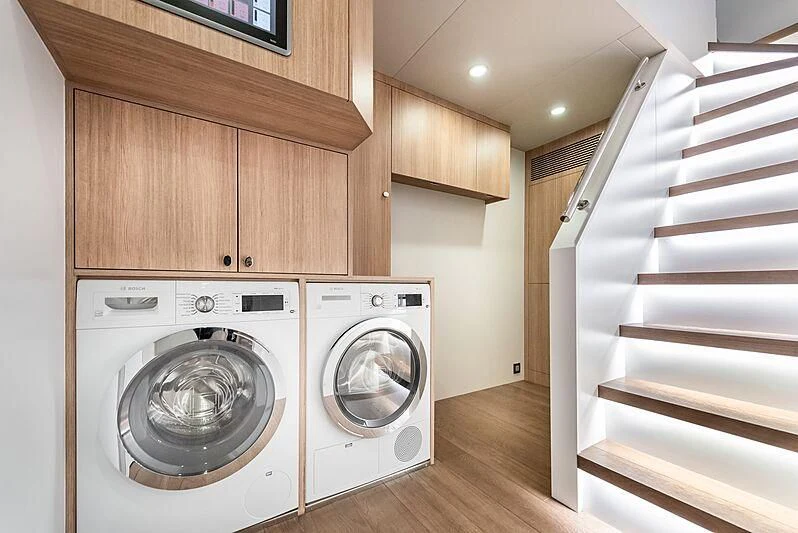 a room with a bed and washer and a staircase aboard MASHA Yacht for Sale
