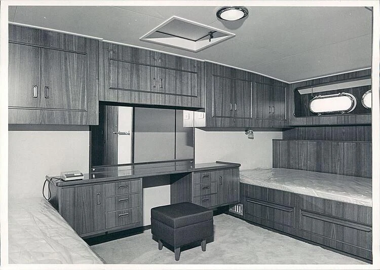 a room with a bed and desk aboard MAGICA STELLA Yacht for Sale