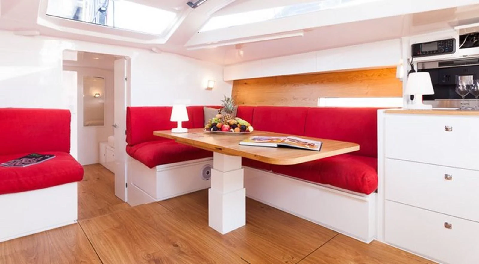 a living room with a red couch and a red couch aboard RED CARPET Yacht for Sale