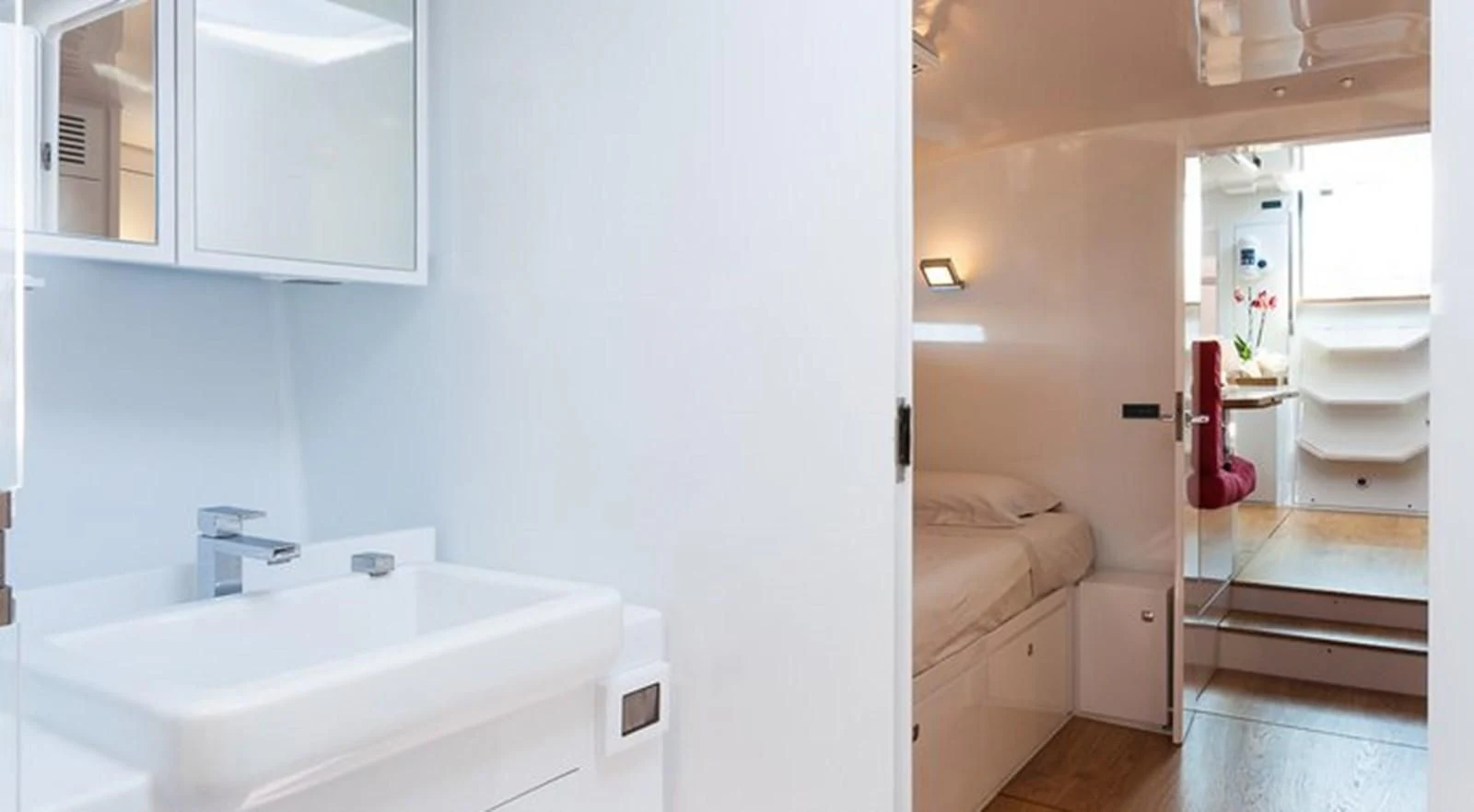 a bathroom with a sink and a bed aboard RED CARPET Yacht for Sale