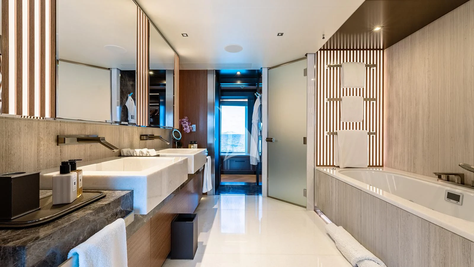 a bathroom with a tub sink and a sink aboard MOSKITO Yacht for Sale