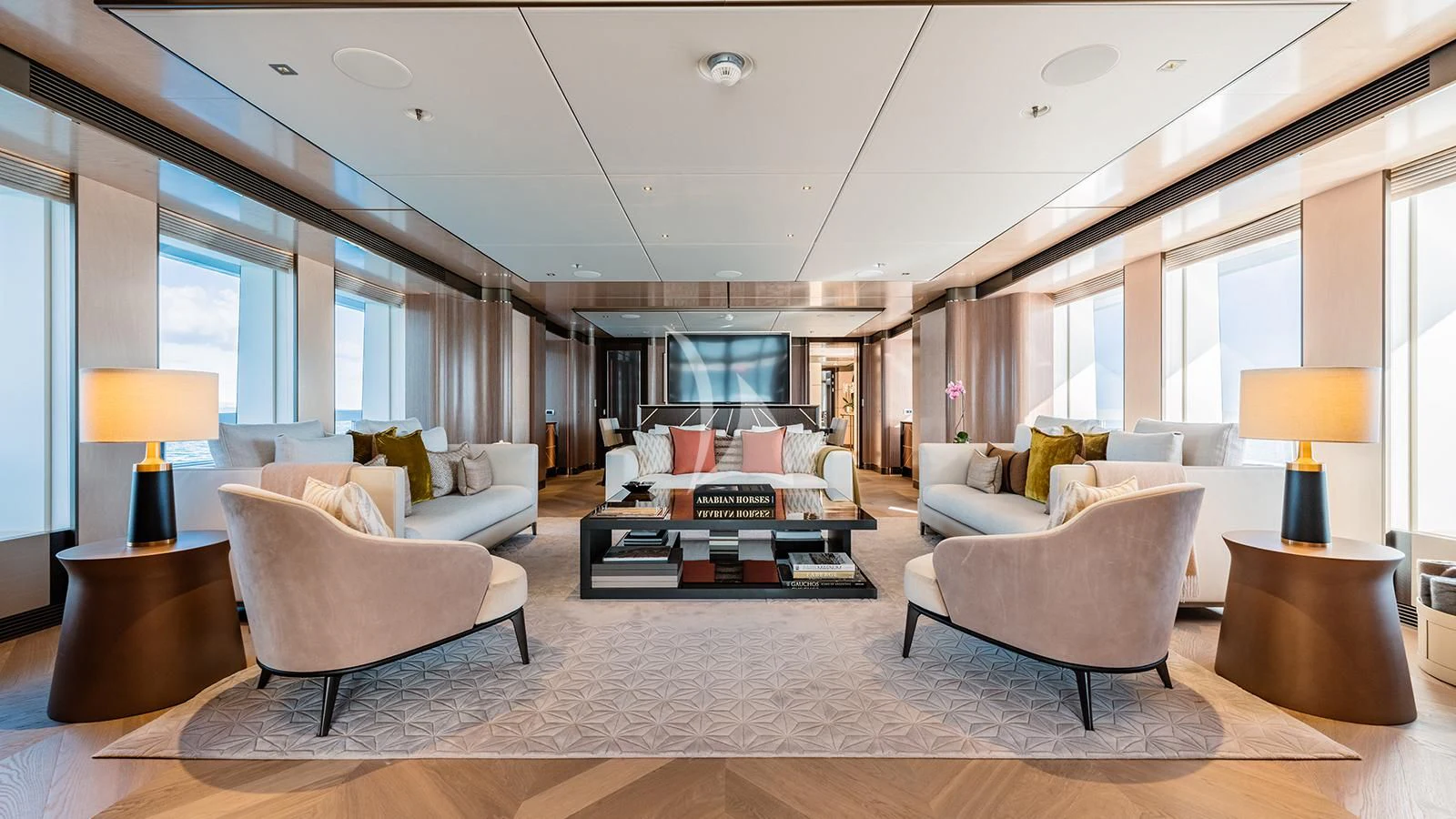 a living room with a large white couch and a large window aboard MOSKITO Yacht for Sale