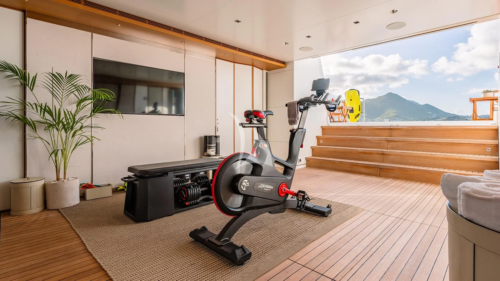 a gym with a large window aboard MOSKITO Yacht for Sale