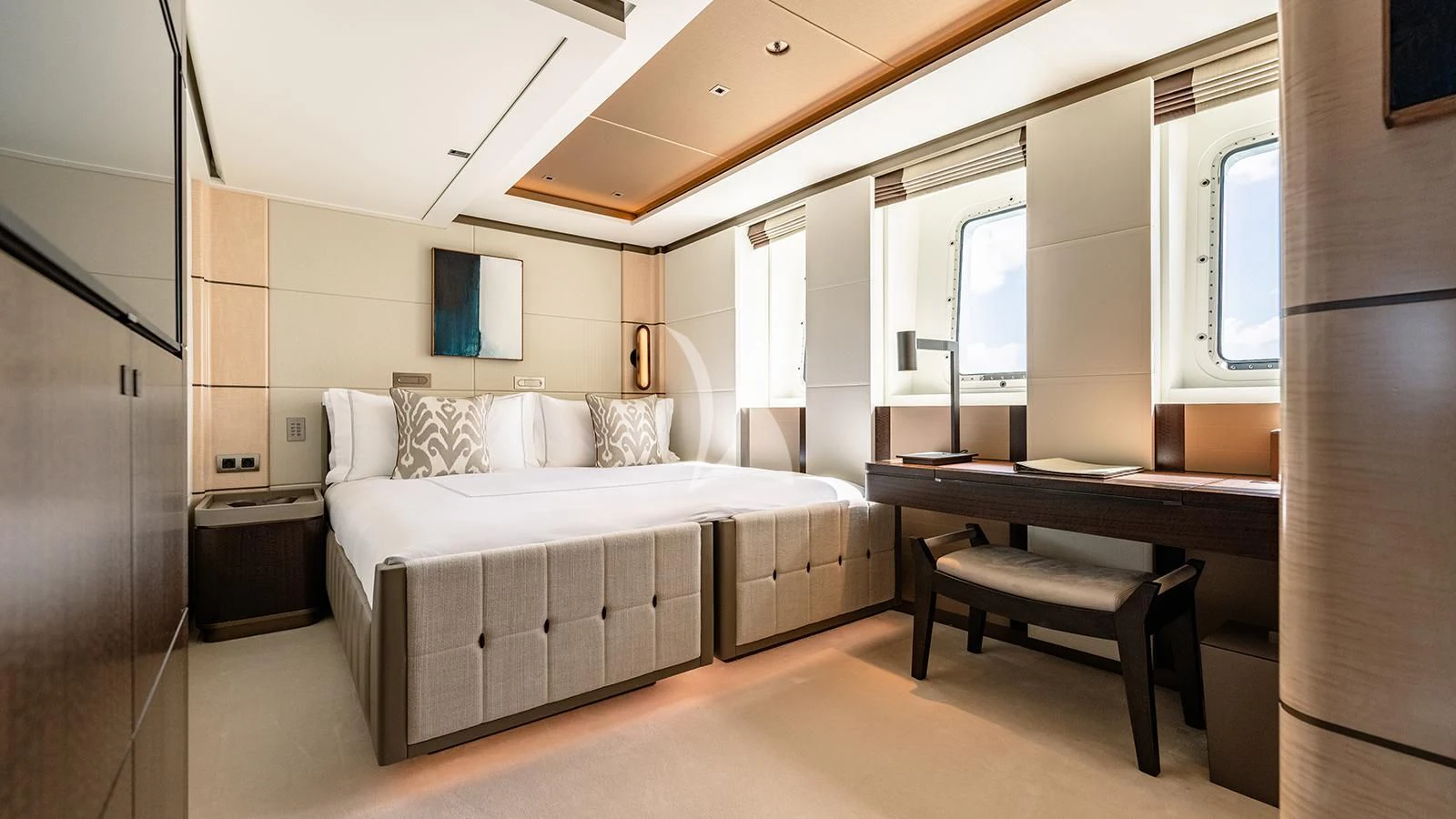 a bedroom with a bed and desk aboard MOSKITO Yacht for Sale
