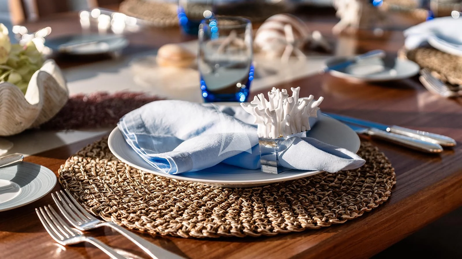 a plate of food and a glass of water on a table aboard MOSKITO Yacht for Sale