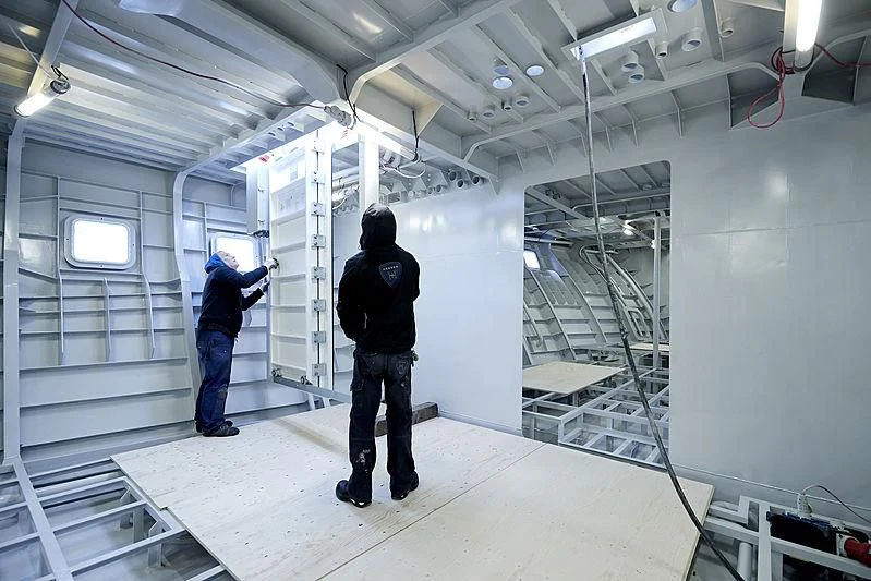 a few people in a factory aboard MOSKITO Yacht for Sale