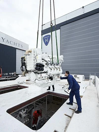 a man standing on a platform next to a large white machine aboard MOSKITO Yacht for Sale