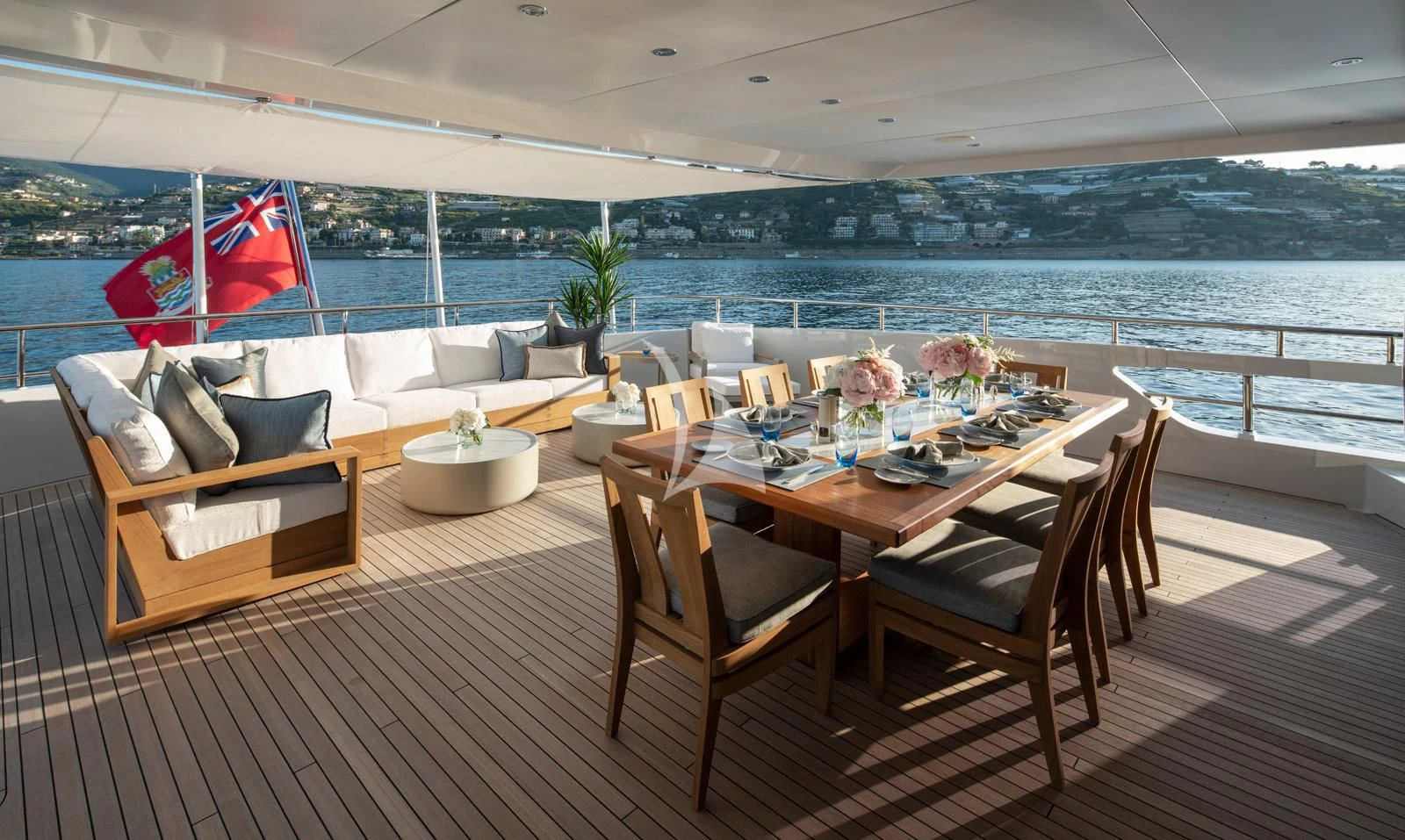 a table and chairs on a deck overlooking a body of water aboard MOSKITO Yacht for Sale