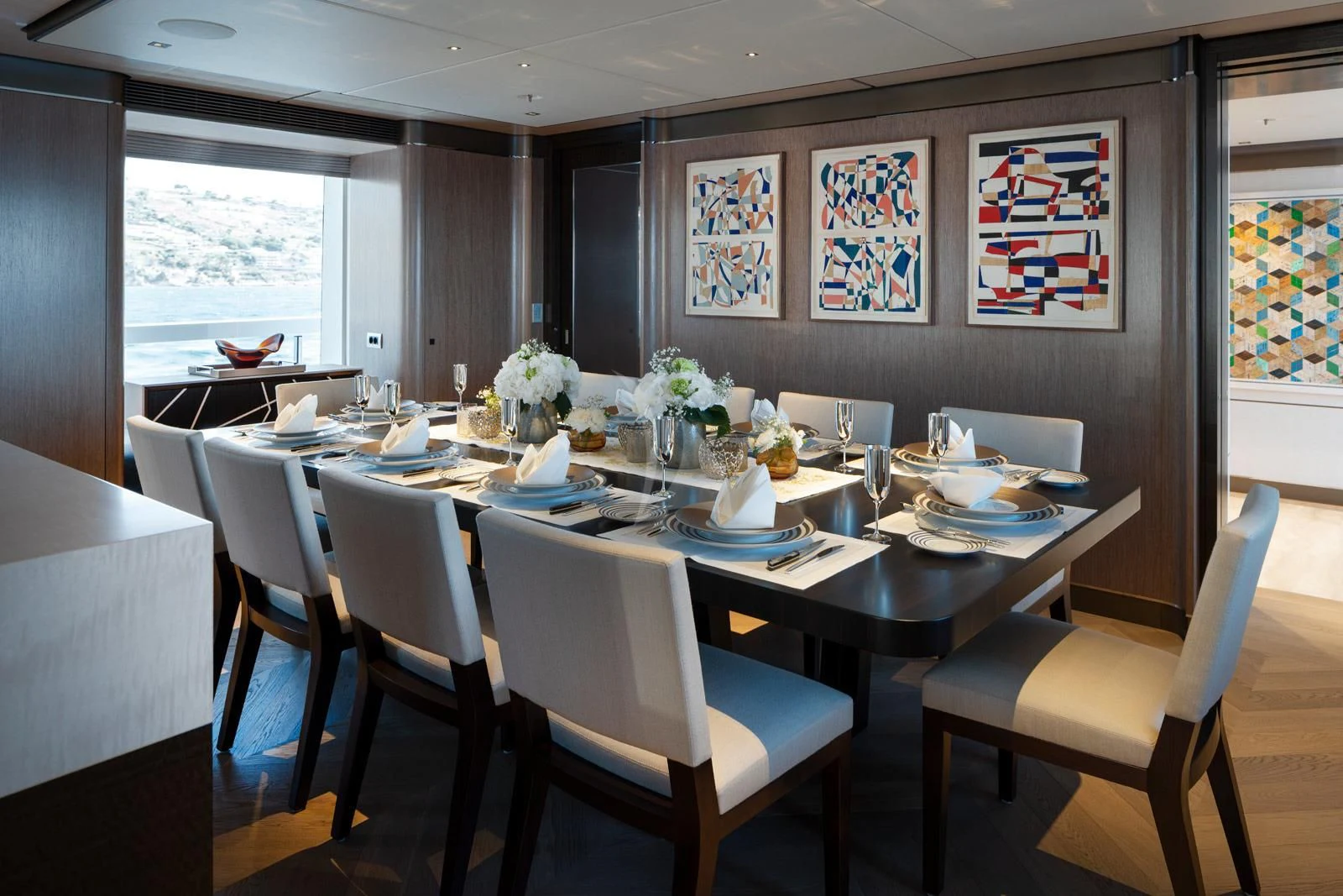 a dining room with white chairs aboard MOSKITO Yacht for Sale