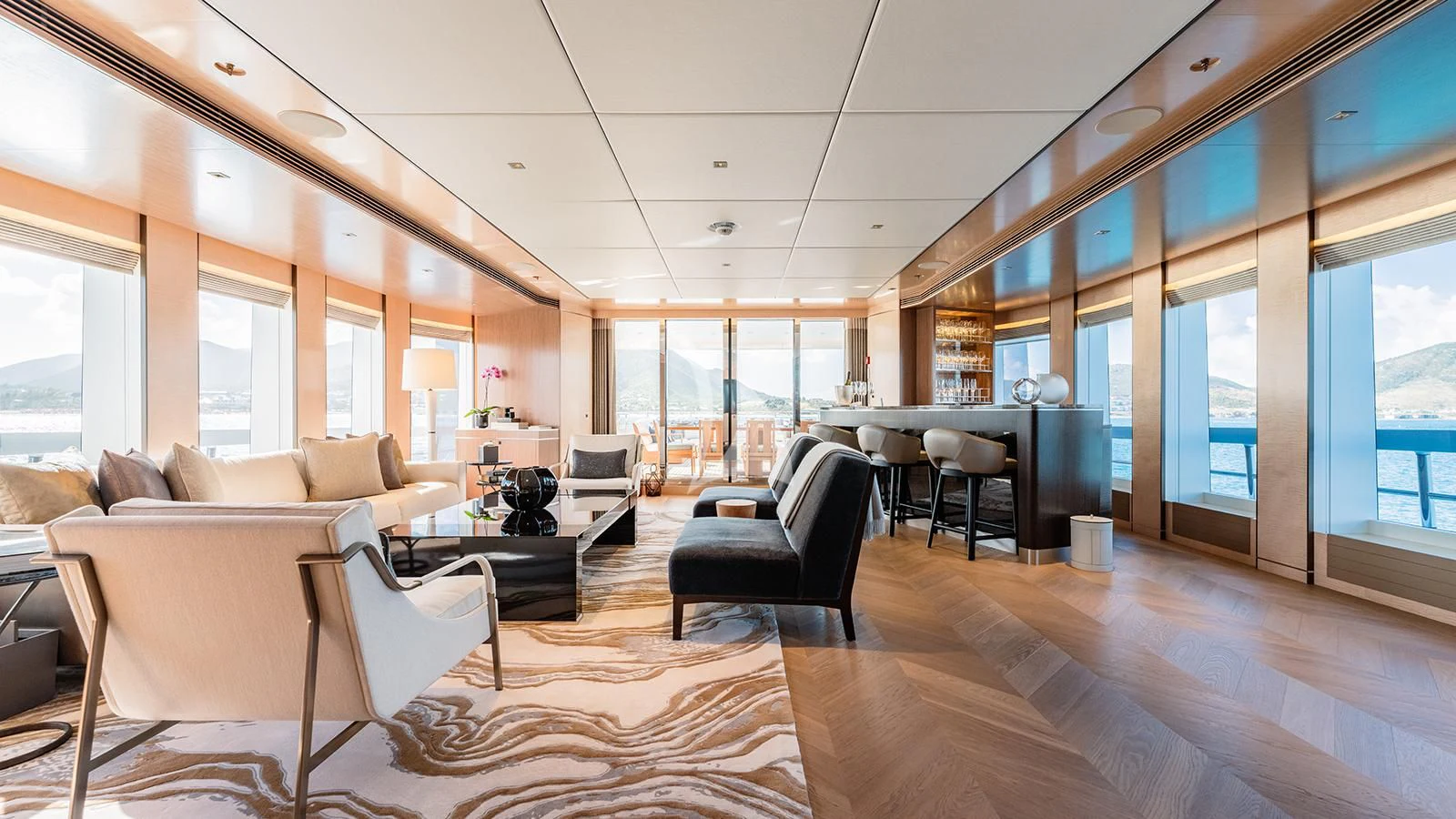 a large living room with a wood floor and a large window aboard MOSKITO Yacht for Sale