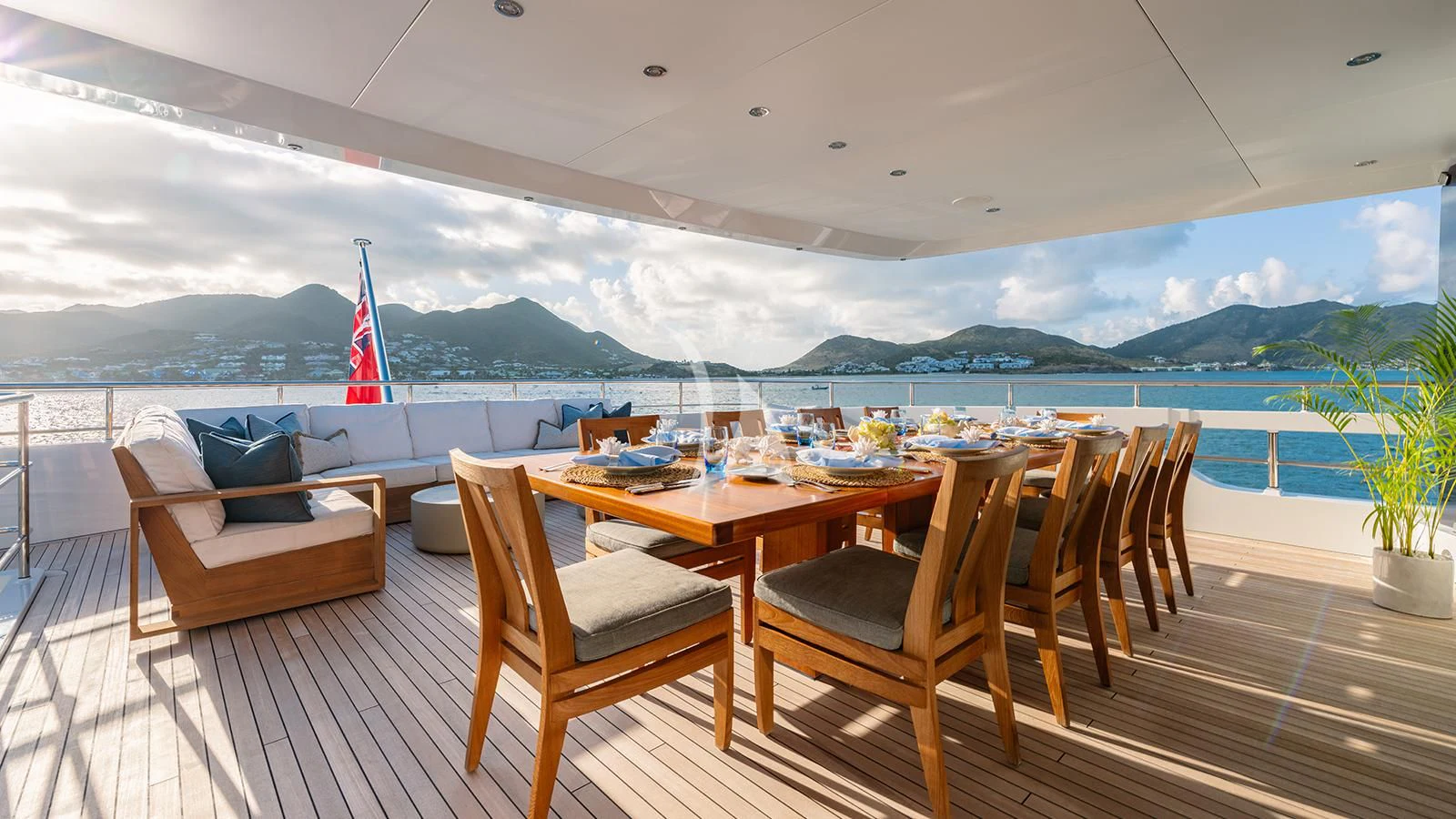 a deck with chairs and a table on it aboard MOSKITO Yacht for Sale