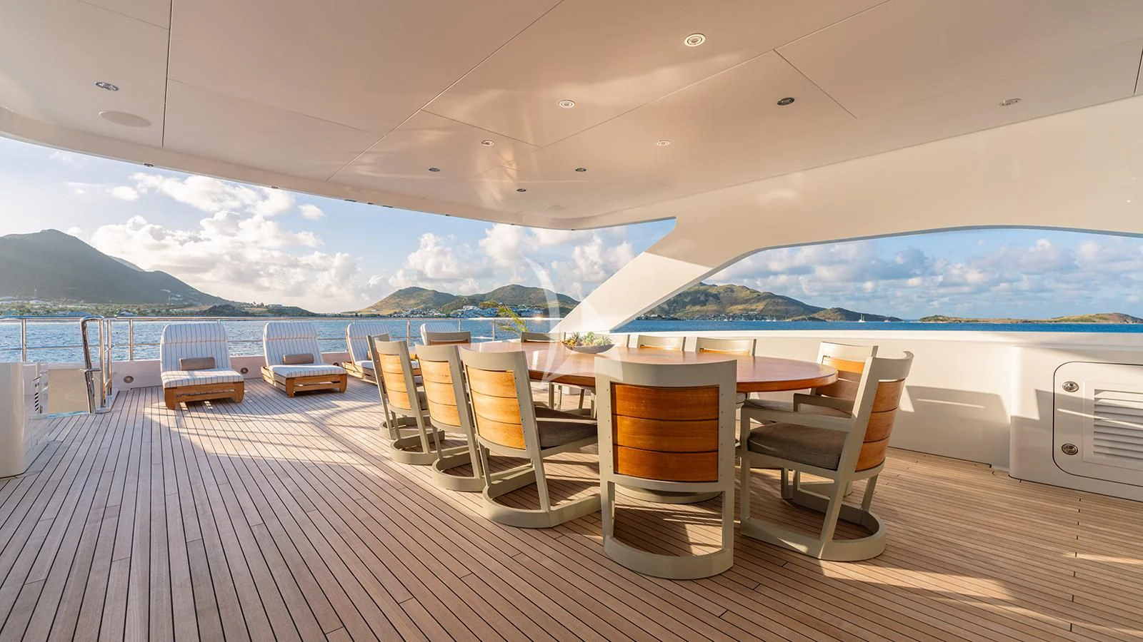 a deck with chairs and tables on it aboard MOSKITO Yacht for Sale