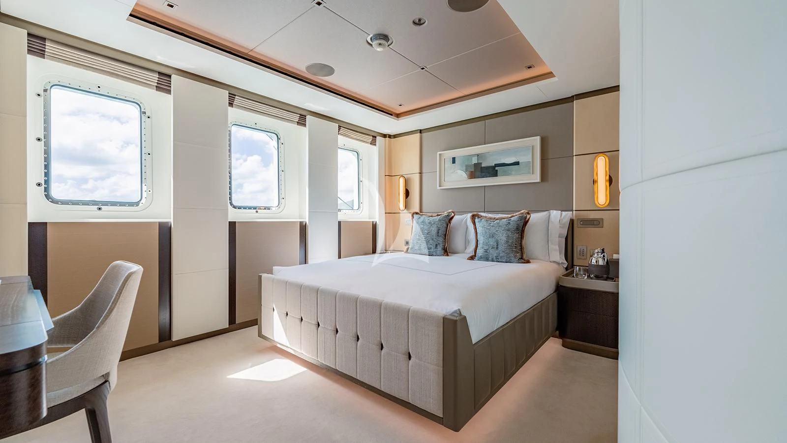 a bedroom with a bed and a chair aboard MOSKITO Yacht for Sale