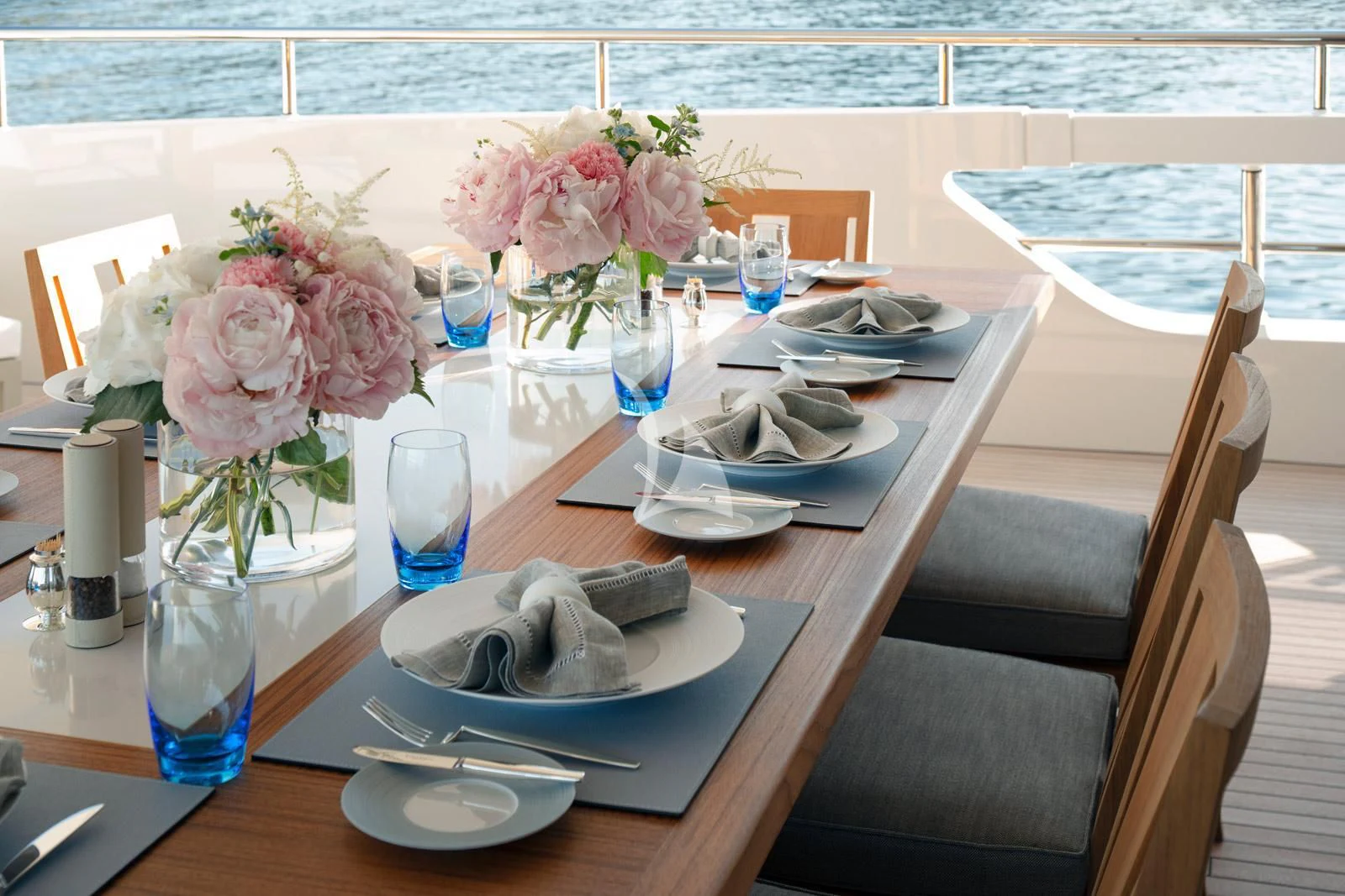 a table with plates and flowers aboard MOSKITO Yacht for Sale