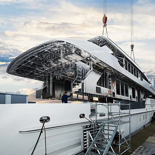 a large white boat with a person standing on the deck aboard MOSKITO Yacht for Sale