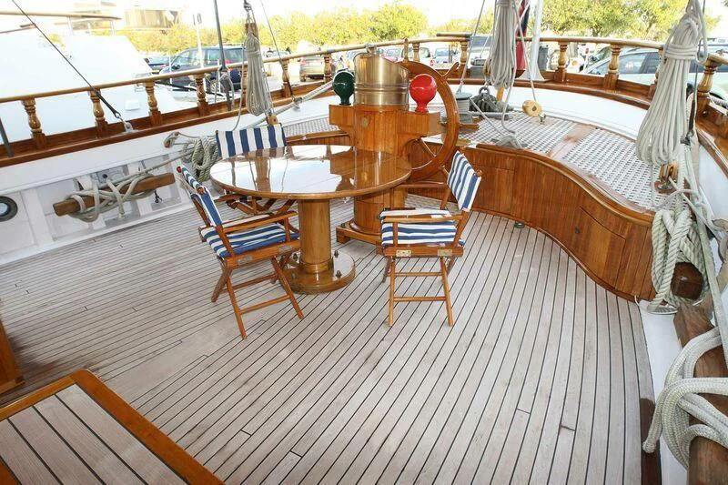 a deck with chairs and tables aboard LA MAIA Yacht for Sale