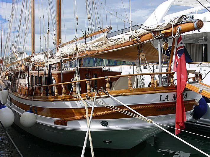 a boat with a red and white sail aboard LA MAIA Yacht for Sale