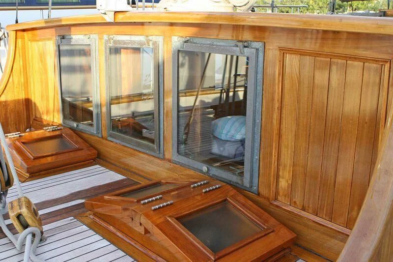 a wooden cabinet with a mirror aboard LA MAIA Yacht for Sale