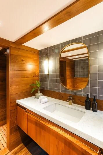 a bathroom with a large mirror aboard CELESTIA Yacht for Sale