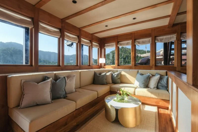 a living room with a couch and a table aboard CELESTIA Yacht for Sale