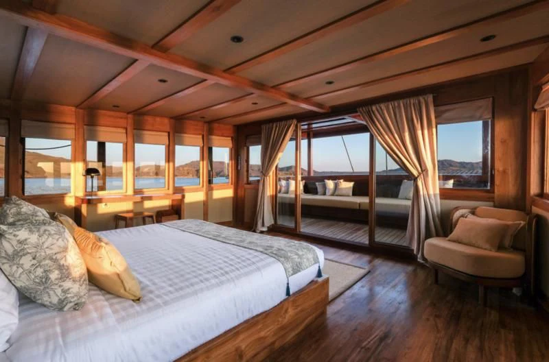 a large bed in a room aboard CELESTIA Yacht for Sale