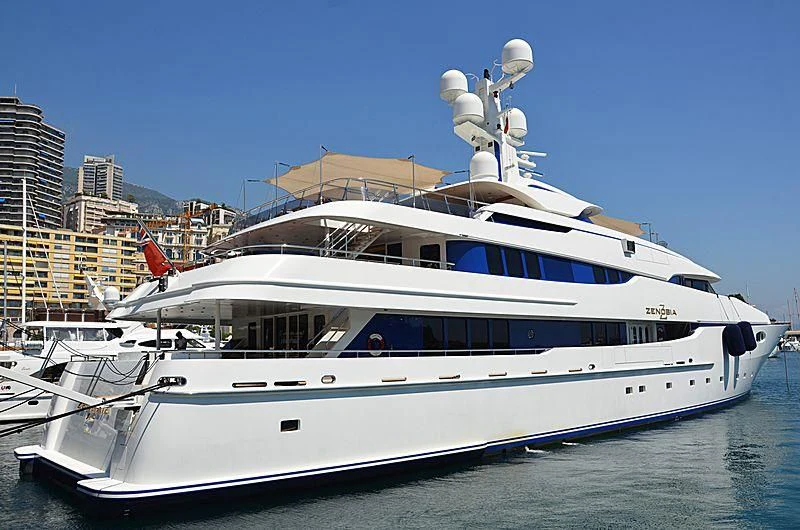 a large white yacht in a harbor aboard ZENOBIA Yacht for Sale