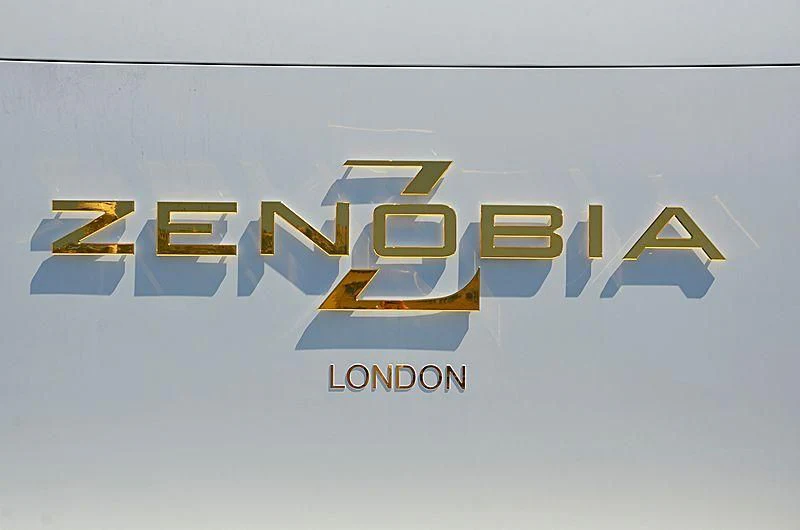 a logo of a company aboard ZENOBIA Yacht for Sale