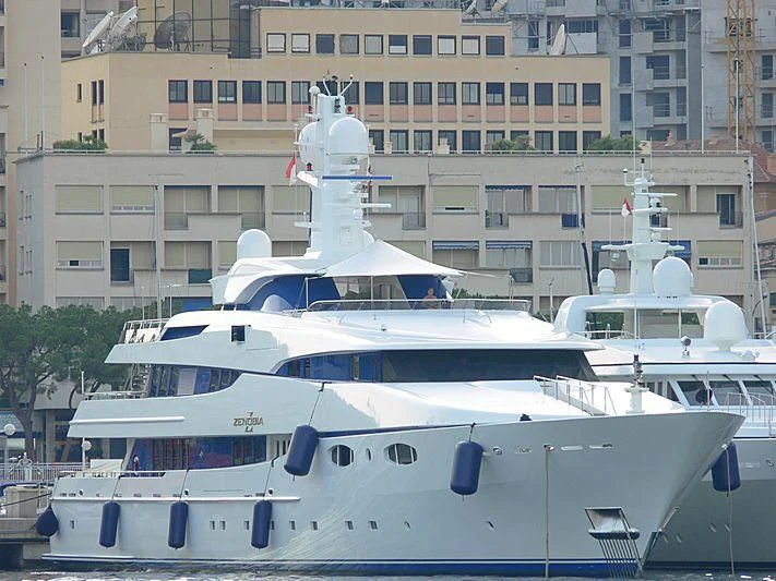 a large white boat in a harbor aboard ZENOBIA Yacht for Sale