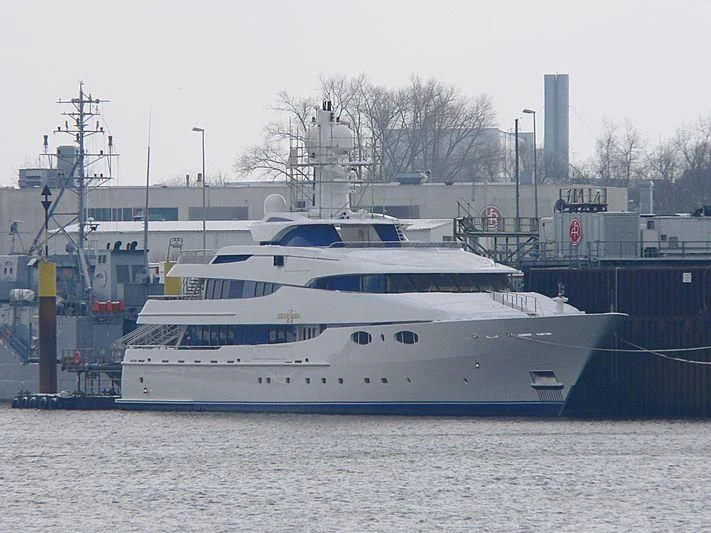 a large white boat sits in a harbor aboard ZENOBIA Yacht for Sale