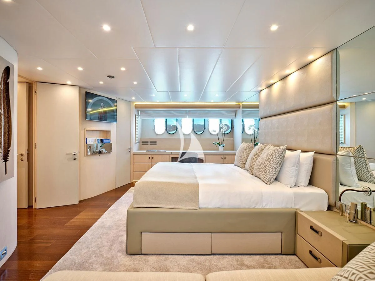 a bedroom with a bed and a mirror aboard WHITE KNIGHT Yacht for Sale