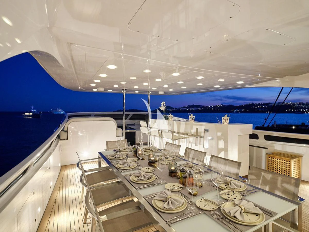 a table with glasses and plates on it aboard WHITE KNIGHT Yacht for Sale