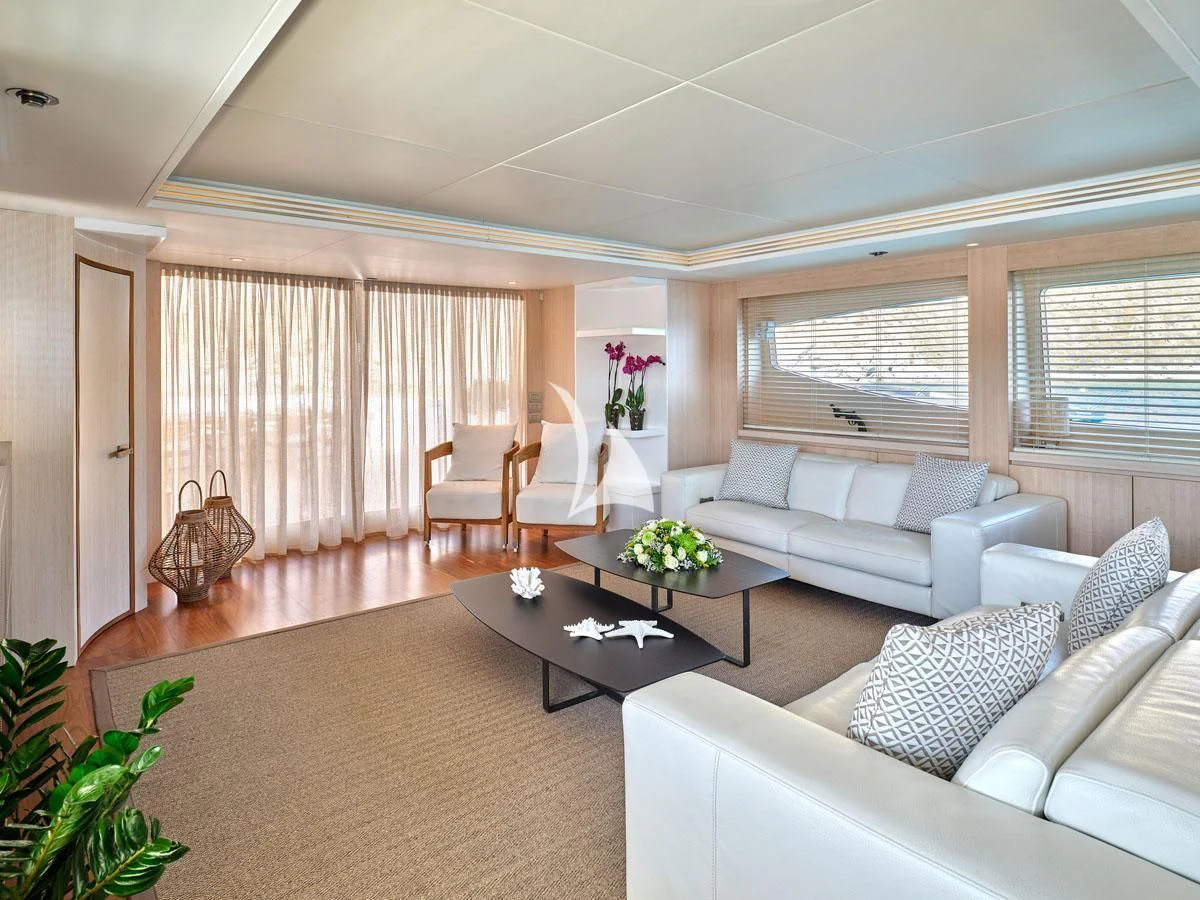 a living room with white couches and a coffee table aboard WHITE KNIGHT Yacht for Sale