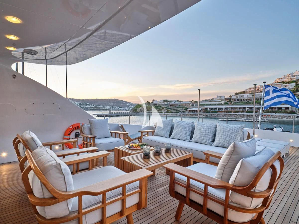 a patio with a table and chairs aboard WHITE KNIGHT Yacht for Sale