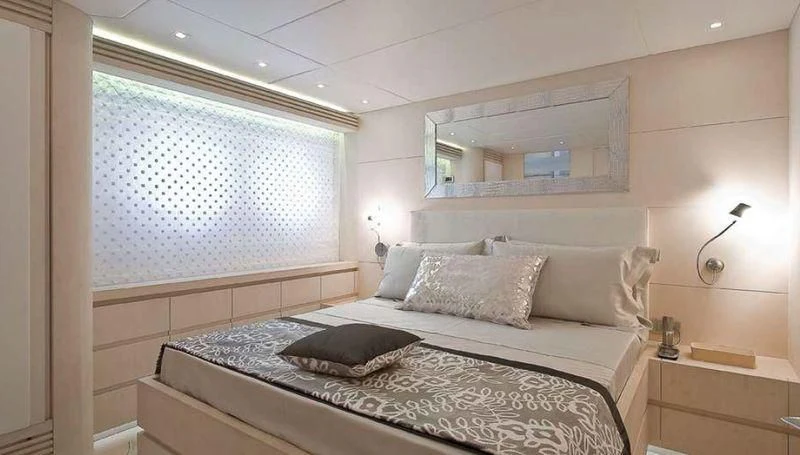a bed with a white bed spread aboard WHITE KNIGHT Yacht for Sale