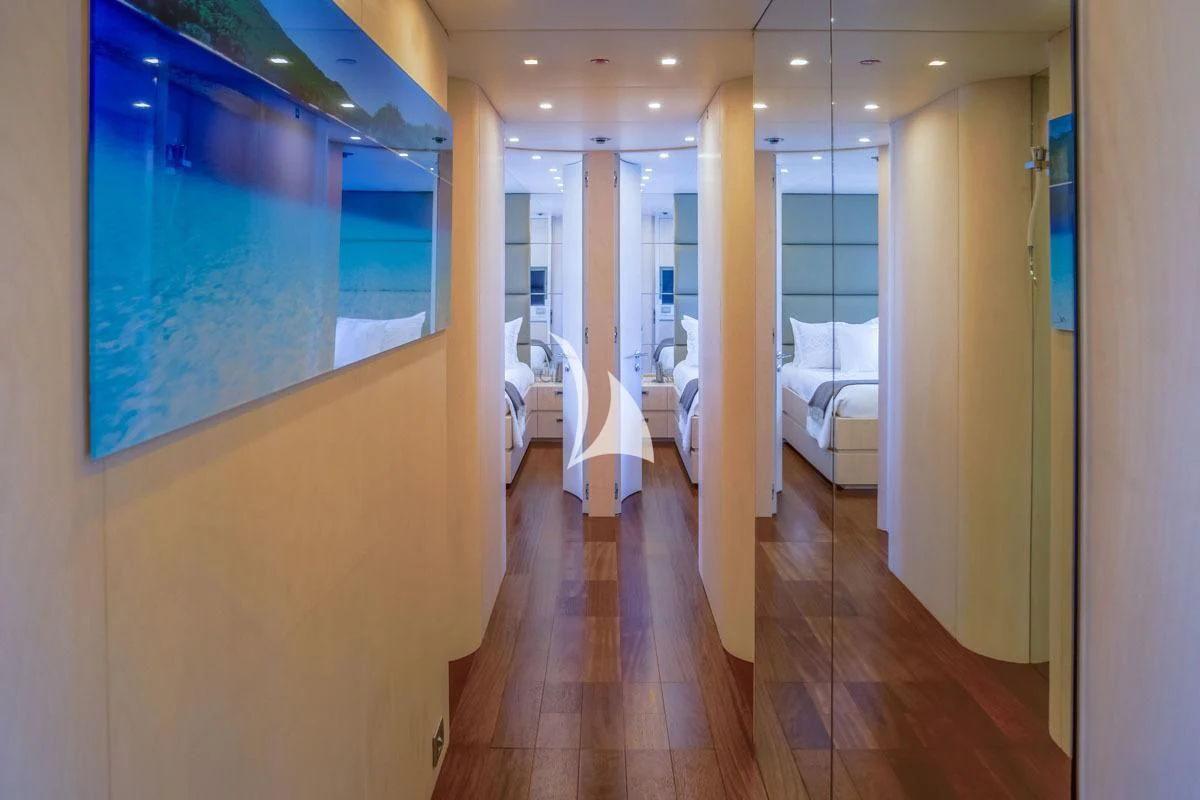 a room with a wood floor and white bed and a blue painting aboard WHITE KNIGHT Yacht for Sale