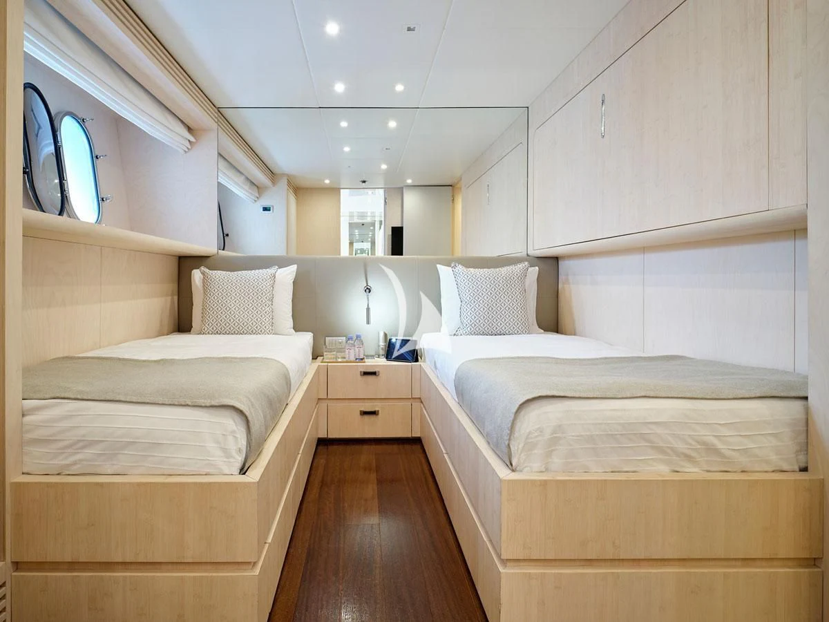 a room with beds and a wood floor aboard WHITE KNIGHT Yacht for Sale