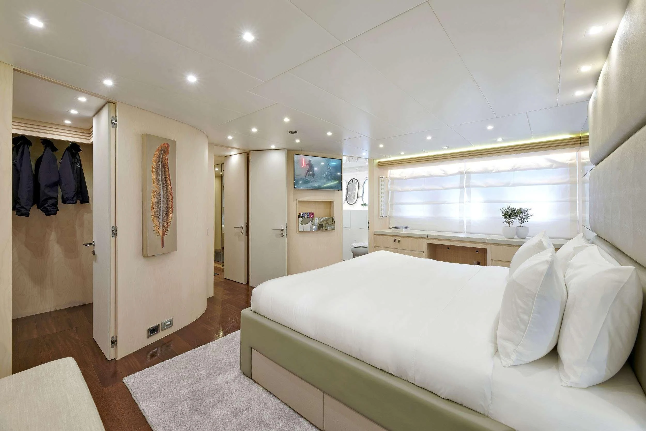a bedroom with a bed and a mirror aboard WHITE KNIGHT Yacht for Sale
