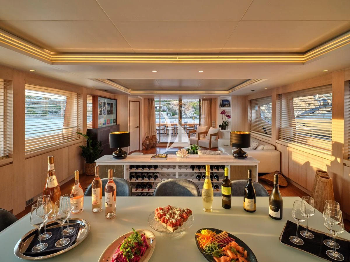 a large dining room with many bottles of wine aboard WHITE KNIGHT Yacht for Sale
