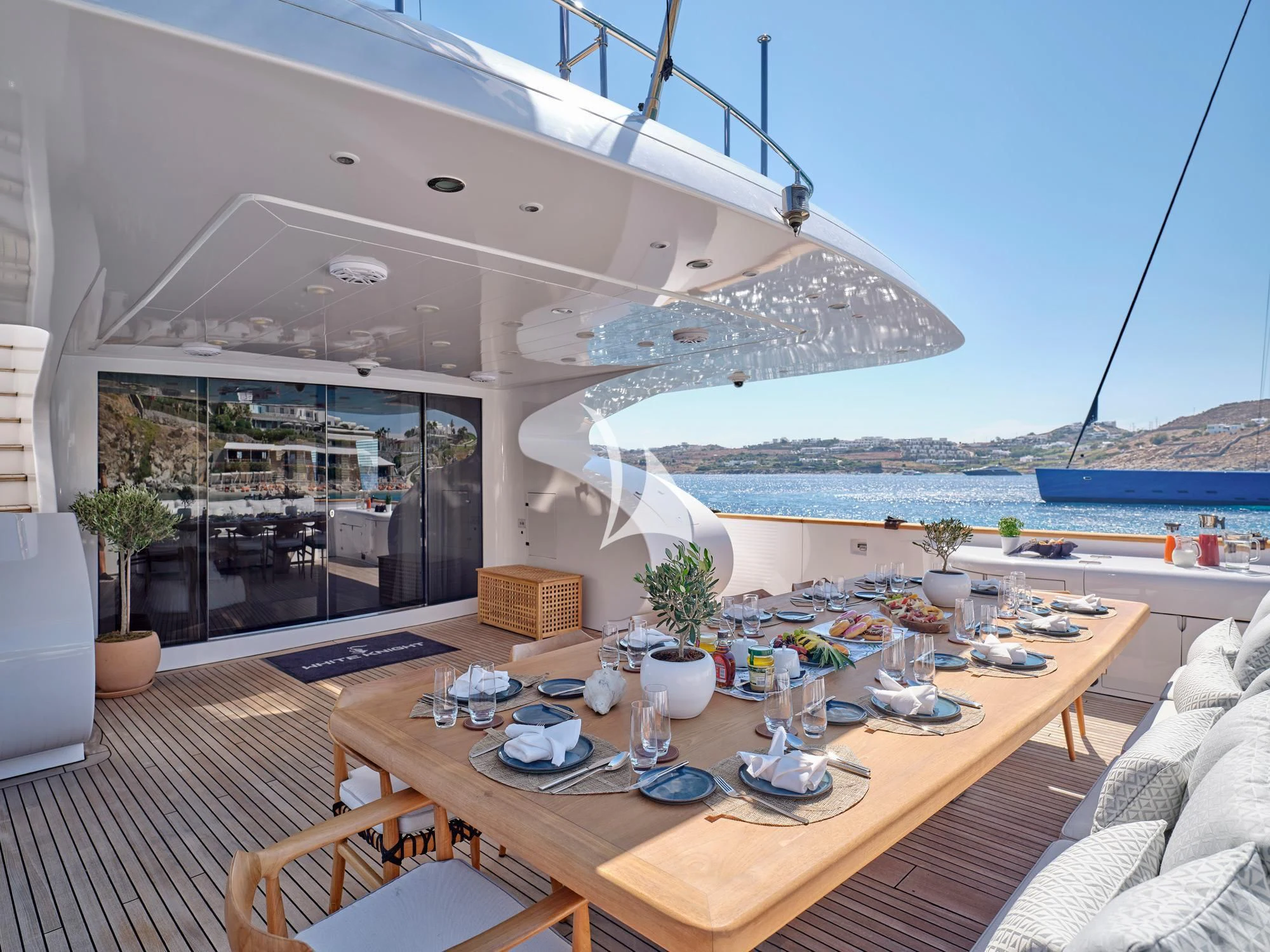 a table with plates and cups on it aboard WHITE KNIGHT Yacht for Sale