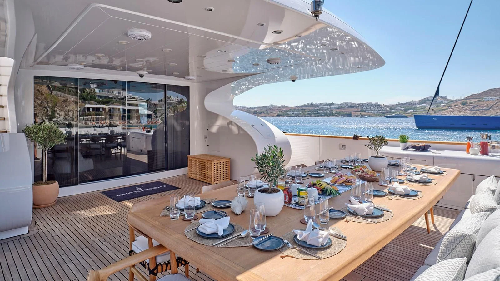a table with plates and cups on it aboard WHITE KNIGHT Yacht for Sale
