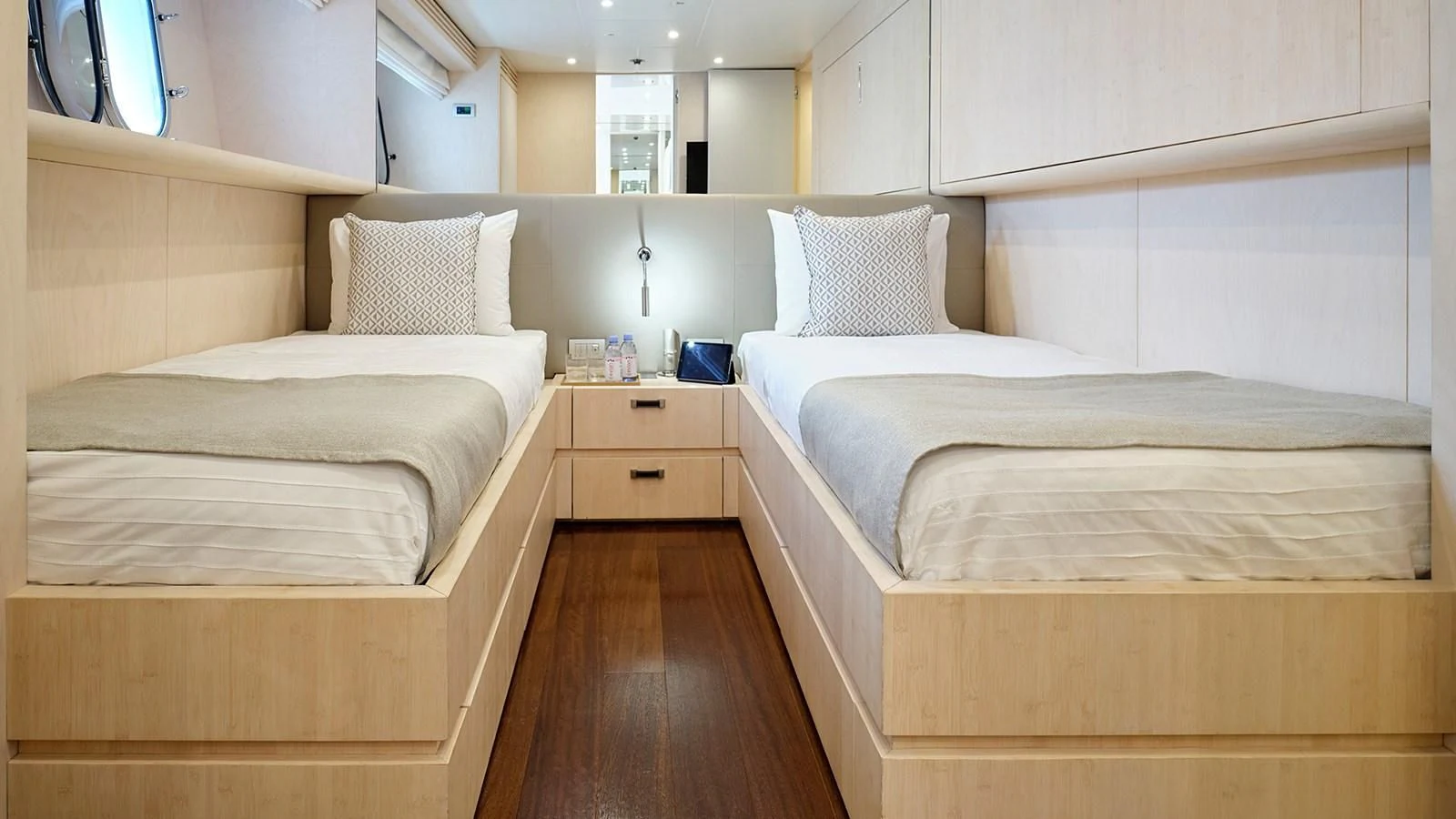 a room with beds and a wood floor aboard WHITE KNIGHT Yacht for Sale