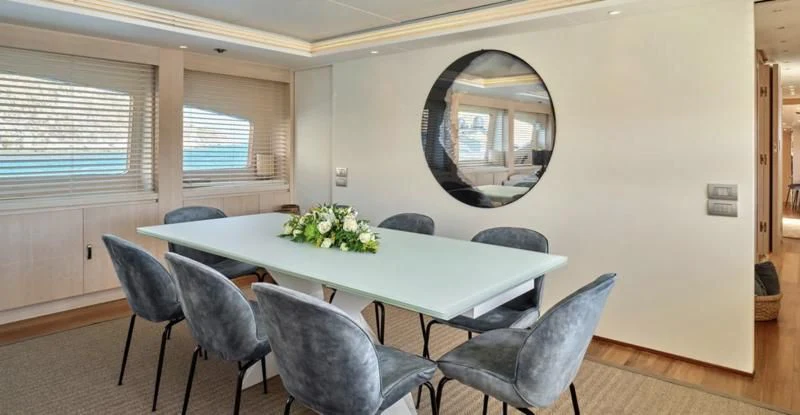 a round table with chairs around it aboard WHITE KNIGHT Yacht for Sale