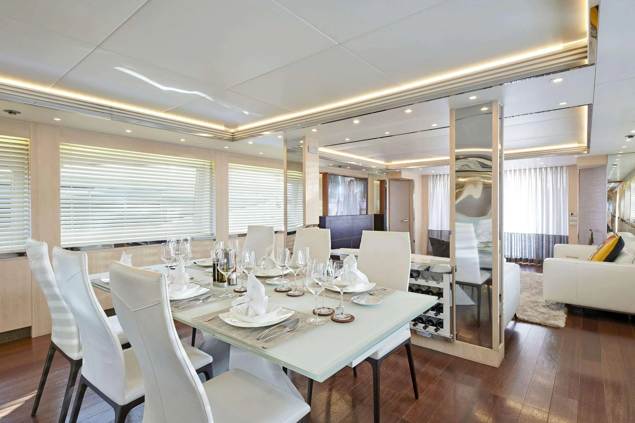 a dining room with white chairs and a table aboard WHITE KNIGHT Yacht for Sale