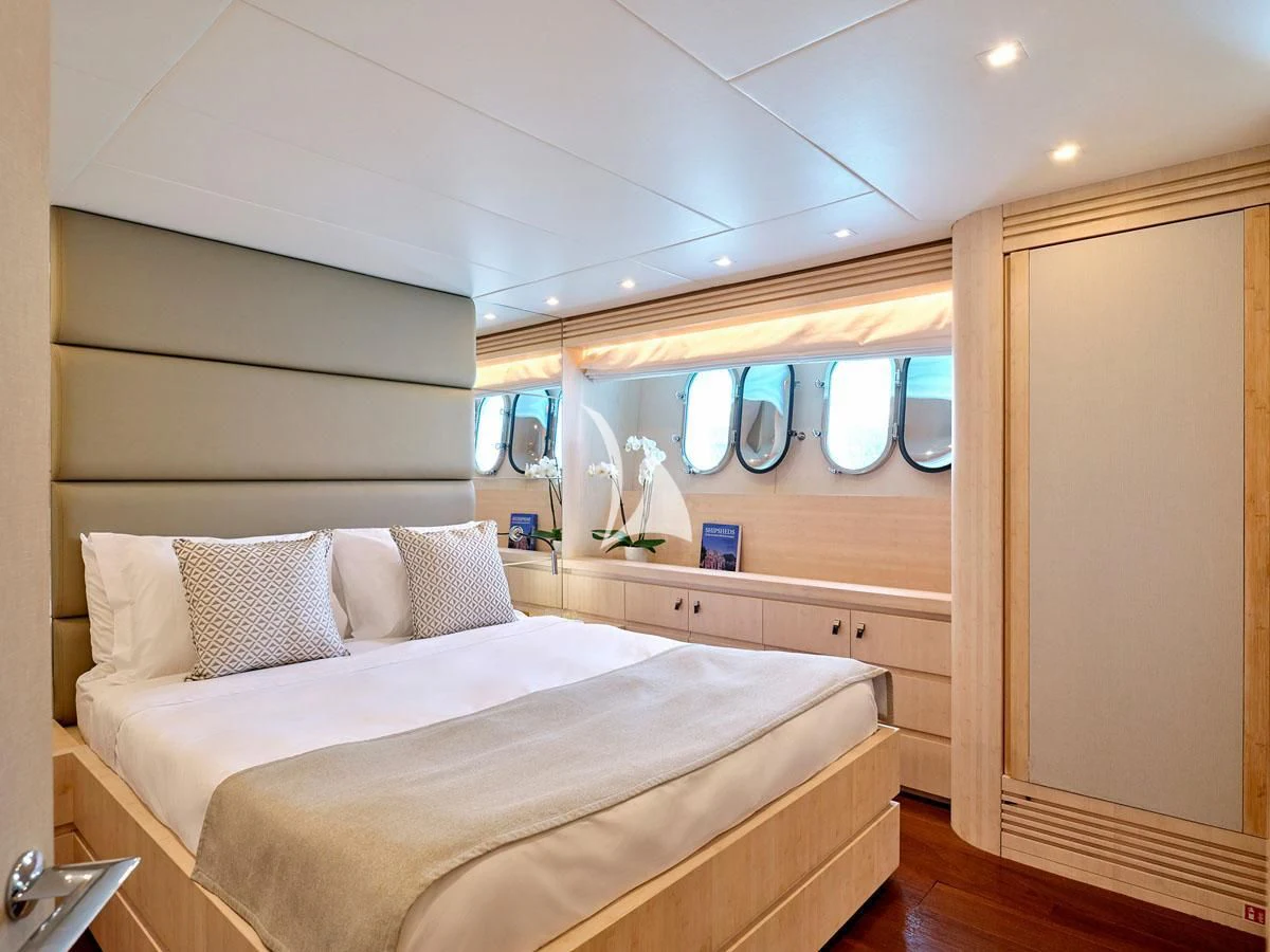 a room with a bed and a mirror aboard WHITE KNIGHT Yacht for Sale